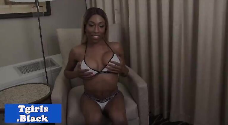 Busty black shemale fingers her ass