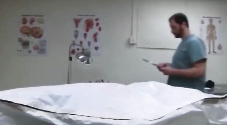 MED Janitor at the Mortuary opens the refrigerator drawers at night p.