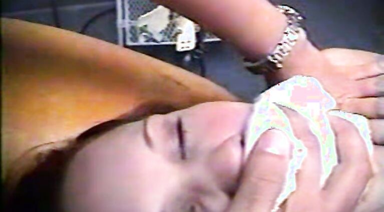 Hot MILF sucking cock in an XXX rape video laying flat on the bed.